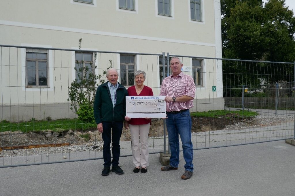Drei Personen übergeben symbolischen Scheck an Hospiz Polling.