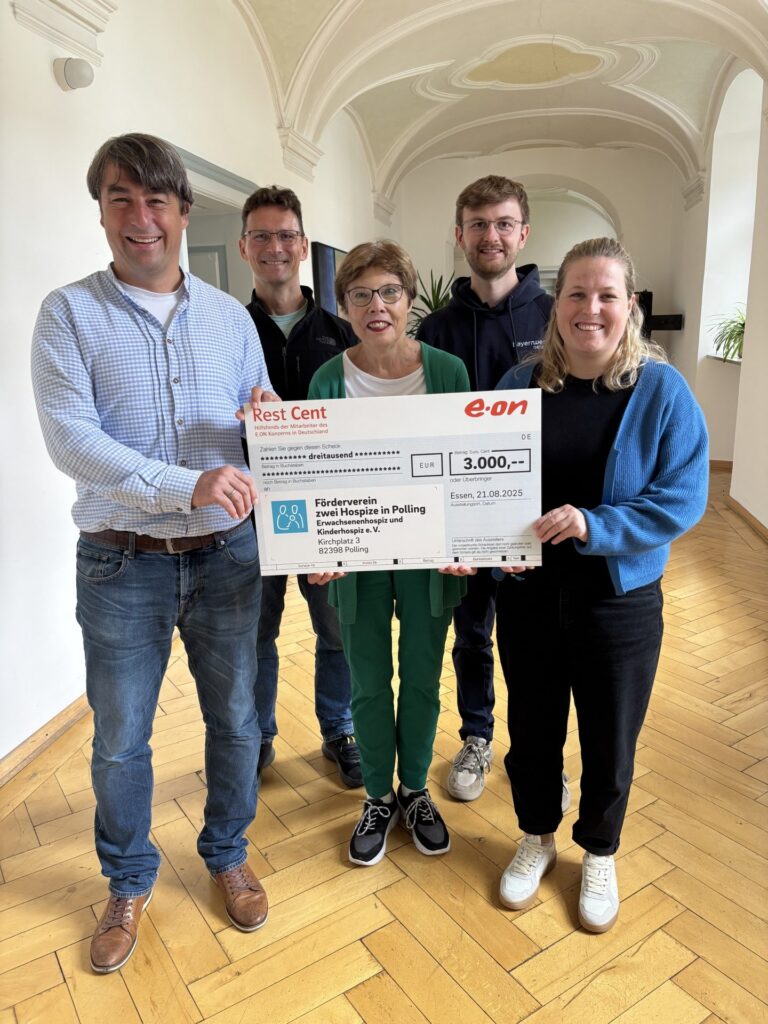 Gruppe hält E.ON-Spendenscheck, freundliche Stimmung, Hospiz Polling.